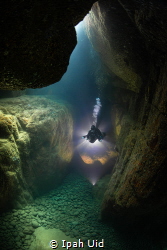 A beautiful open to a small cave... with tech divers by Ipah Uid 